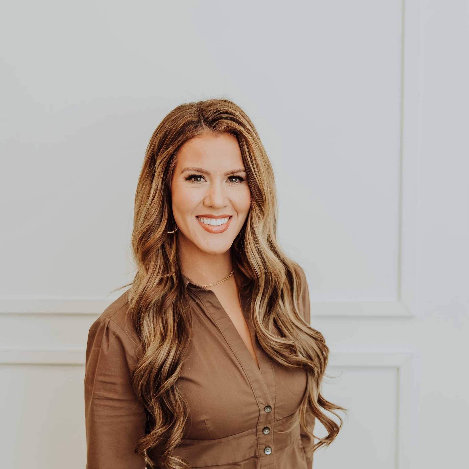 Portrait of Brianna, a professional stylist at Bombshell Salon & Spa, showcasing their expertise and style.