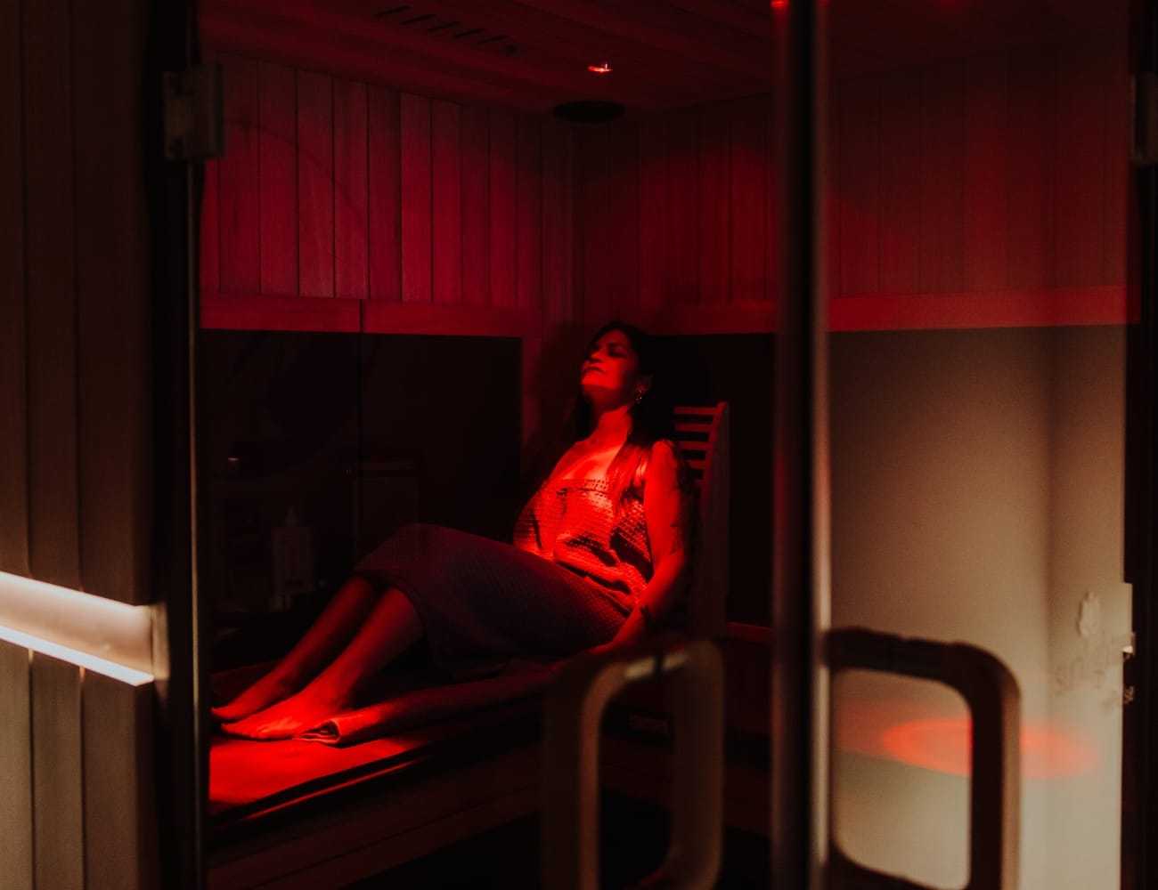 Relaxing in a dimly lit infrared sauna.