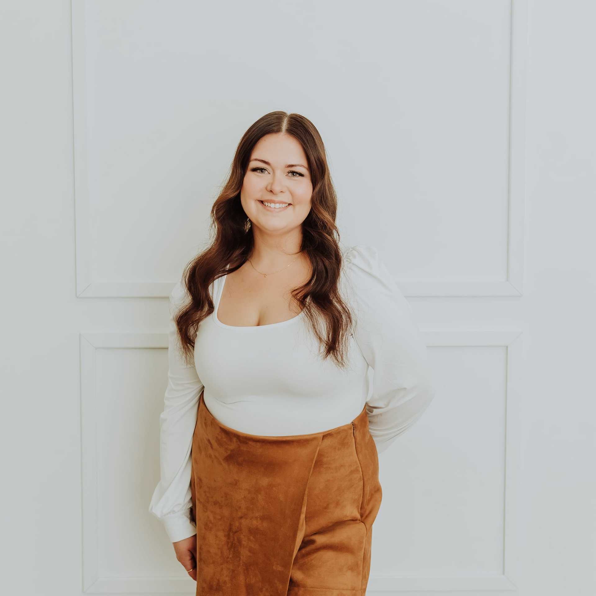 Portrait of Cara, a professional stylist at Bombshell Salon & Spa, showcasing their expertise and style.