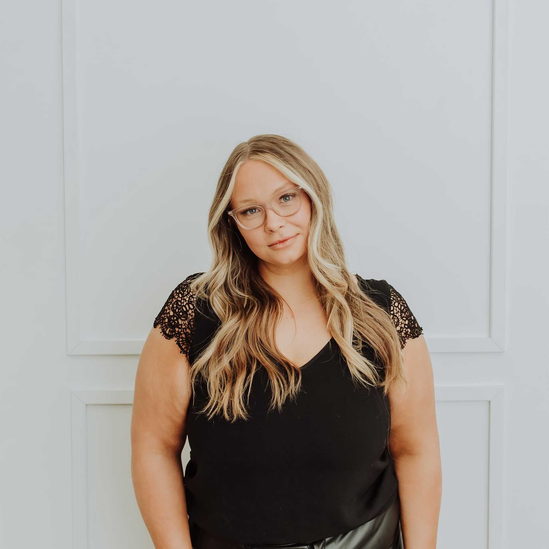 Portrait of Emily, a professional stylist at Bombshell Salon & Spa, showcasing their expertise and style.
