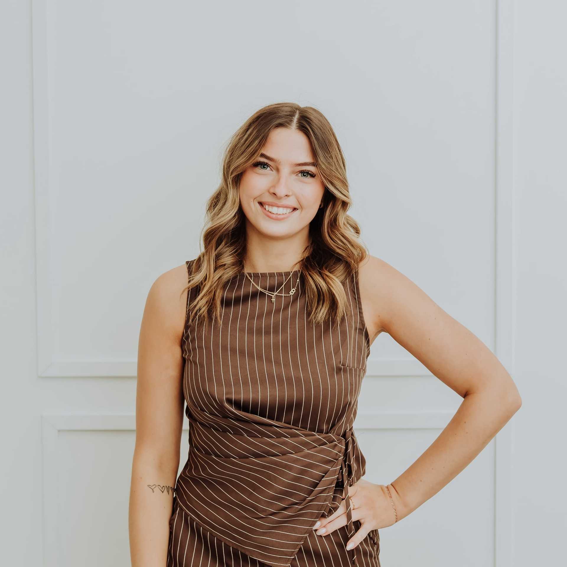 Portrait of Libbie, a professional stylist at Bombshell Salon & Spa, showcasing their expertise and style.