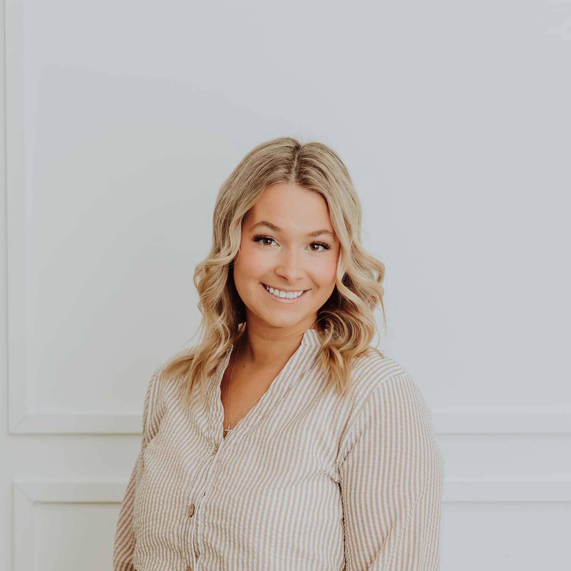 Portrait of Ella, a professional stylist at Bombshell Salon & Spa, showcasing their expertise and style.
