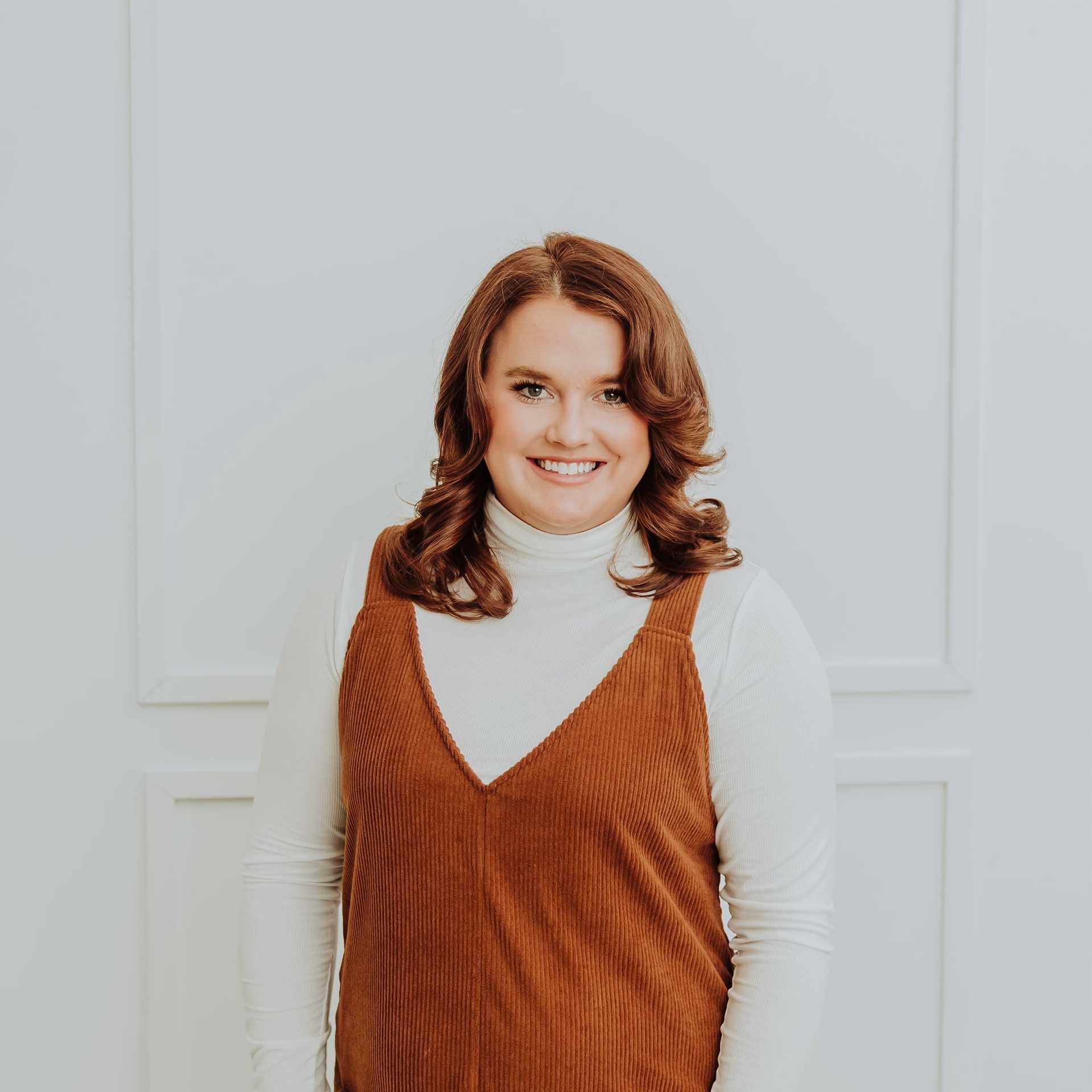 Portrait of Kortney, a professional stylist at Bombshell Salon & Spa, showcasing their expertise and style.