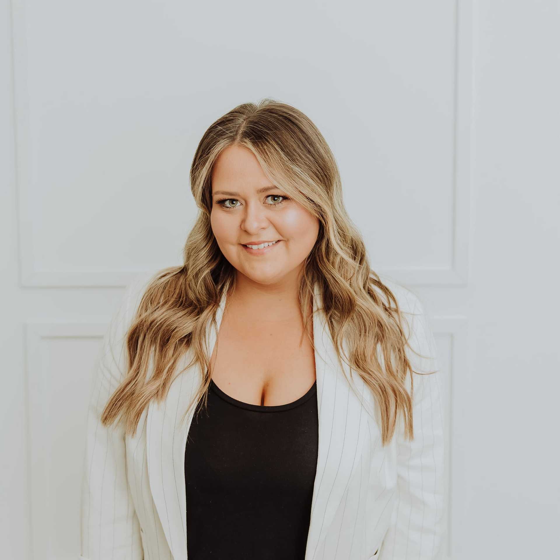 Portrait of Casey, a professional stylist at Bombshell Salon & Spa, showcasing their expertise and style.