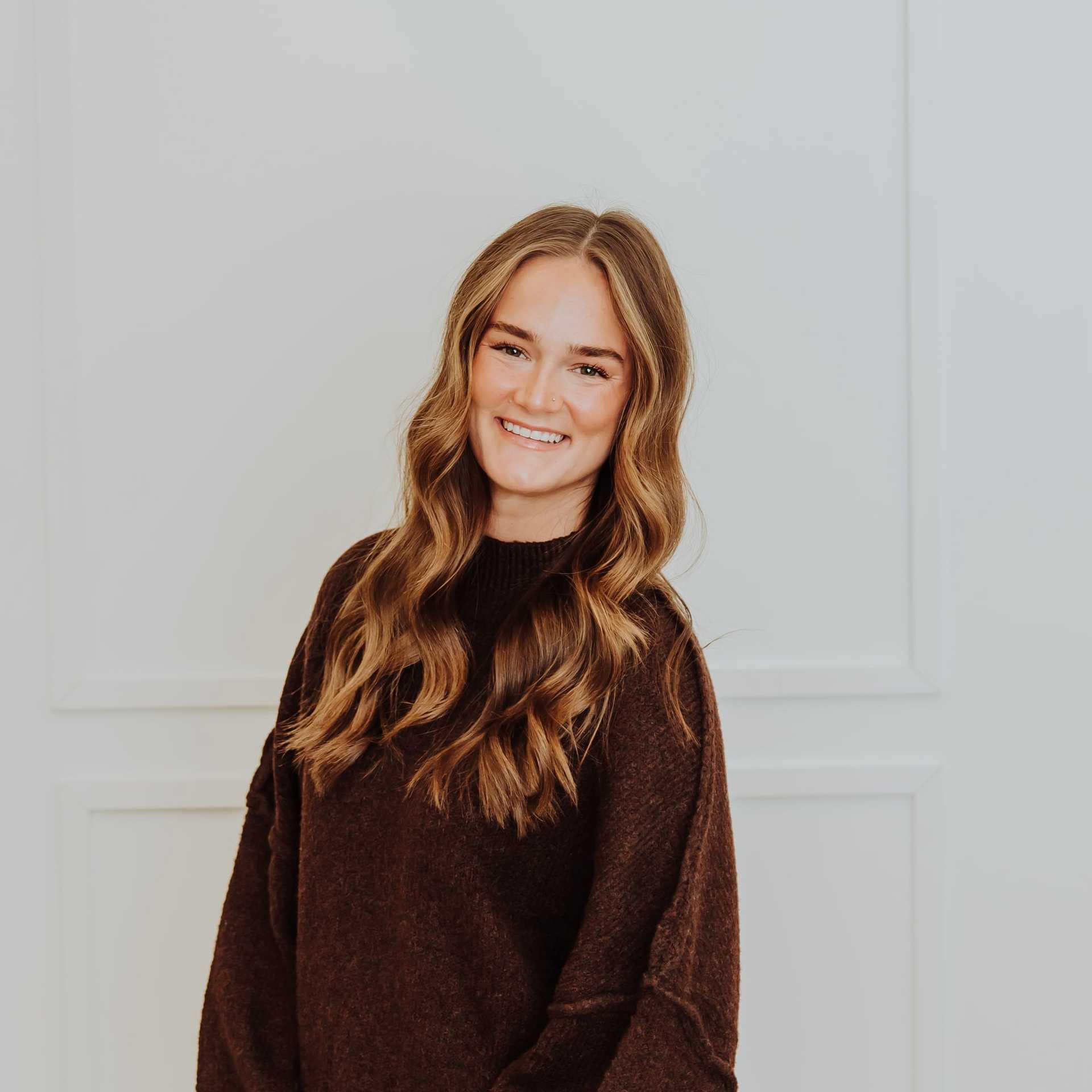Portrait of Kaitlyn, a professional stylist at Bombshell Salon & Spa, showcasing their expertise and style.